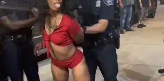 Watch moment a black Woman tries twerking on male police officer after she got arrested (video)
