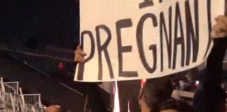 Kourtney Kardashian reveals that she’s pregnant at Blink-182’s show in Los Angeles with a sign that reads “Travis I’m pregnant.”