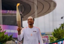 Snoop Dogg carries Olympic torch through Paris ahead of opening ceremony