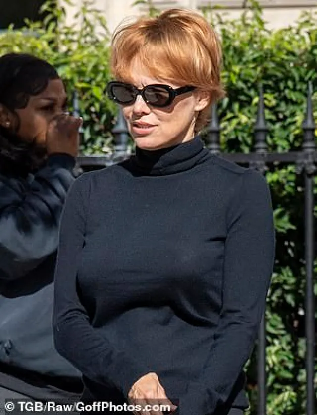 Pamela Anderson Stuns Paris Fashion Week Crowd With Dramatic Red-Haired Transformation